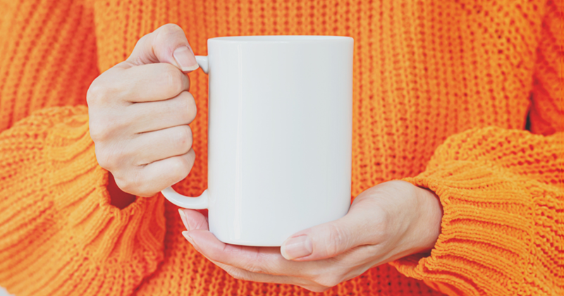 Person Holding a White Mug