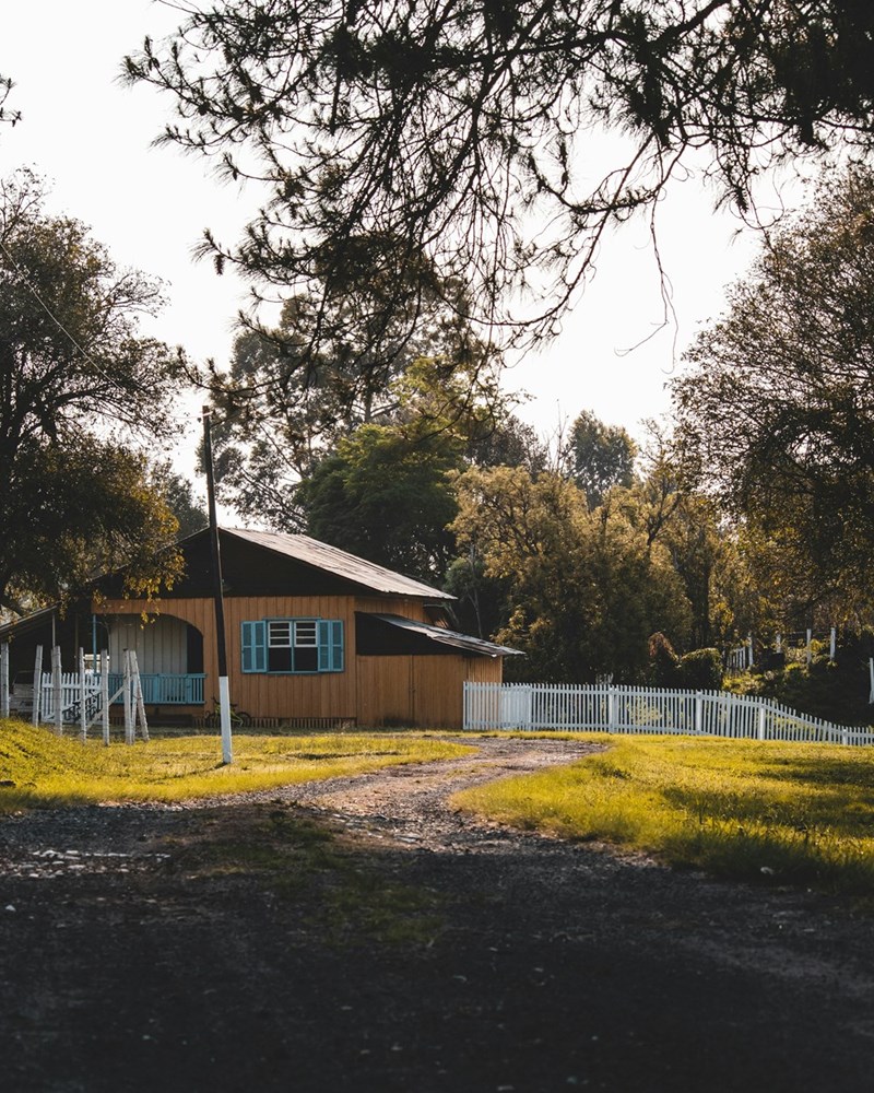 A nice suburban home with a white picket fence on a sunny day (stock).