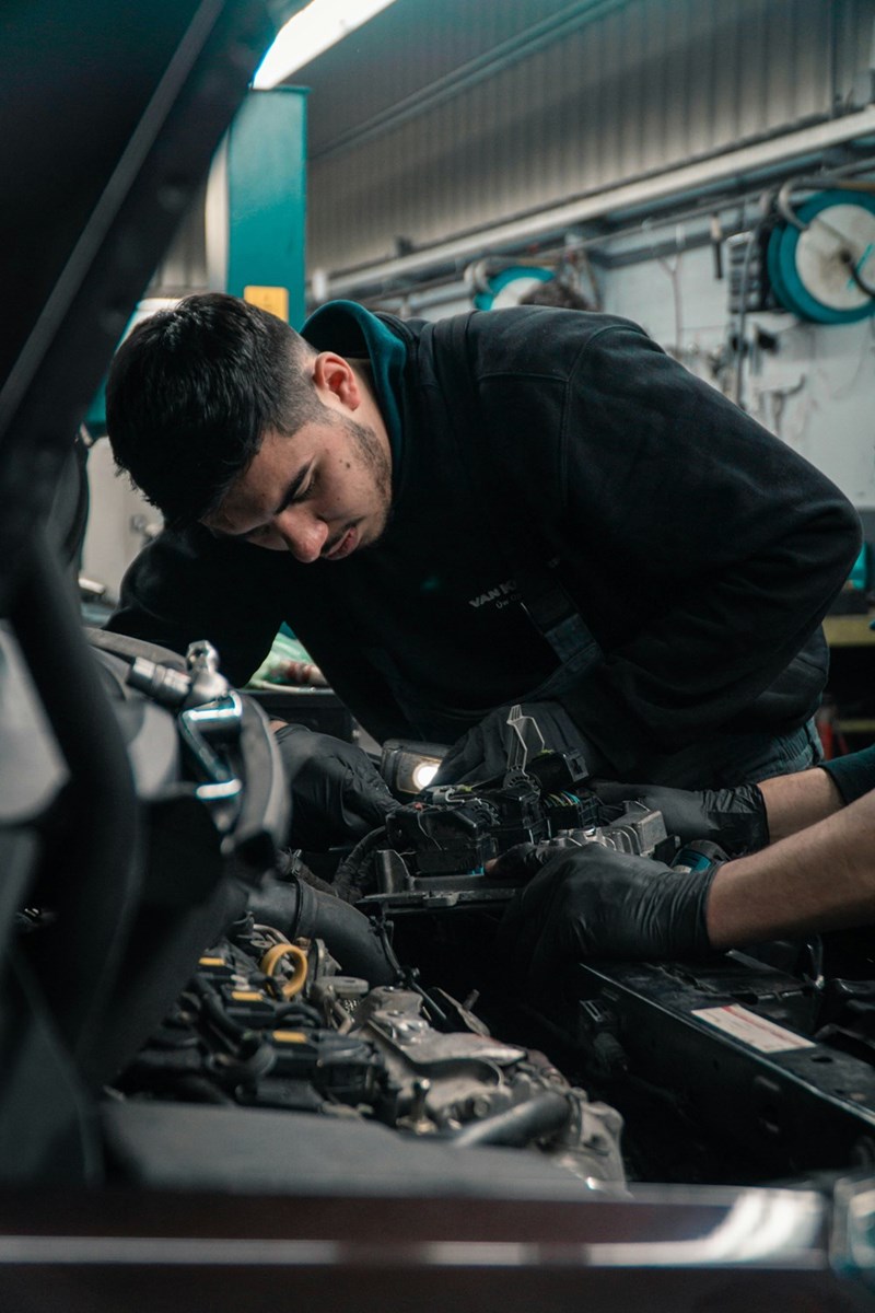 Worker fixing a car, representation