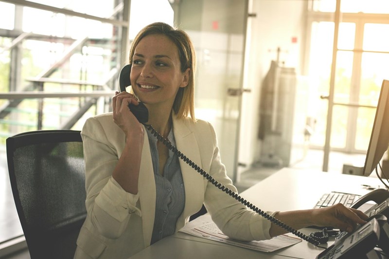 Business woman working in office woman talking on landline phone