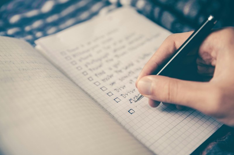 person writing bucket list