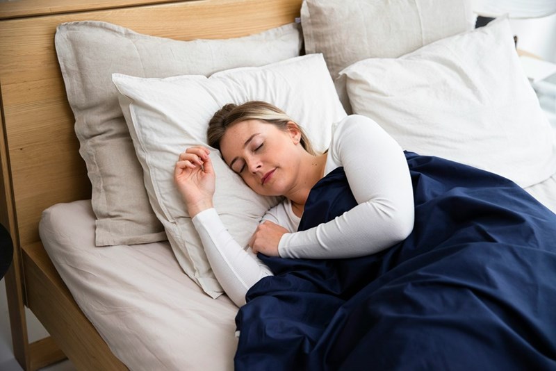 a woman resting her head on a pillow