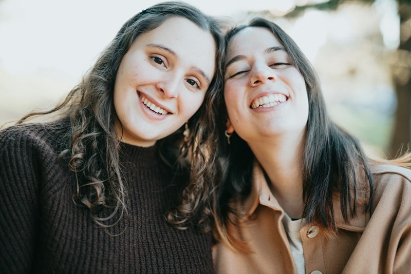 Two sisters sharing a laugh together.