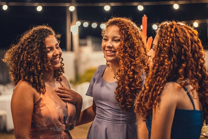 a group of women standing next to each other smiling