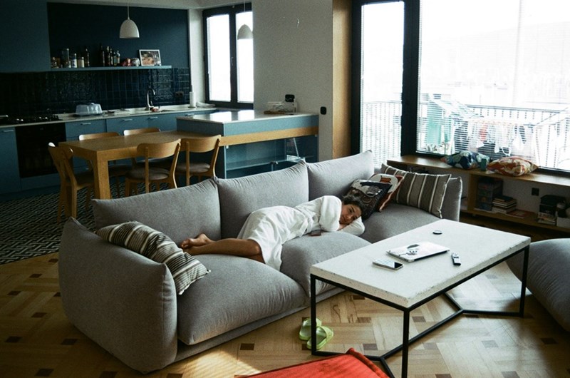 a woman laying on a couch in a robe