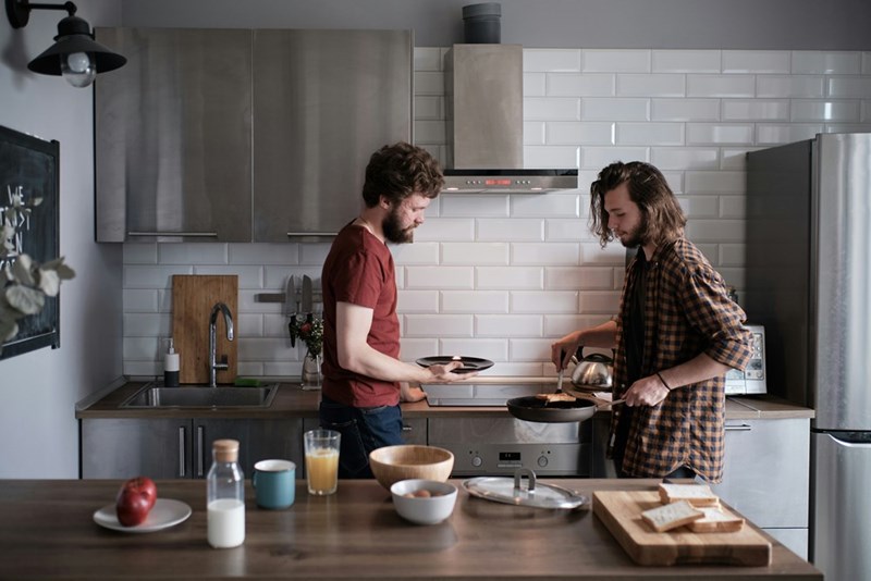 Two men cooking in the kitchen.