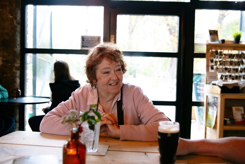 elderly woman smiling at a table