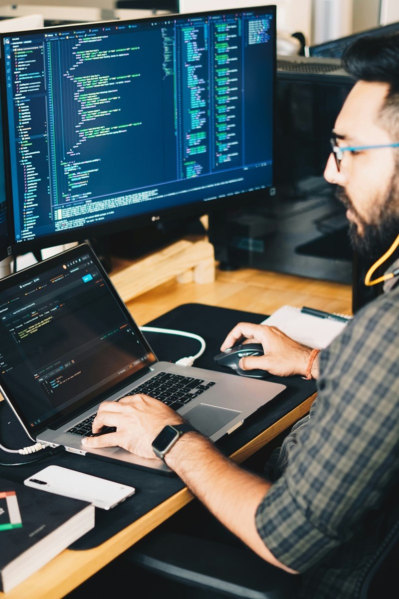man using laptop to code