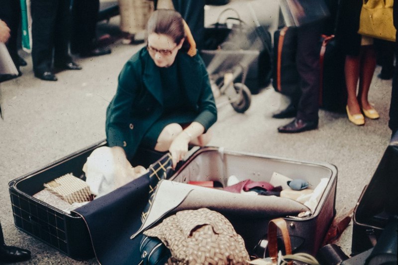 a woman sitting in an open suitcase
