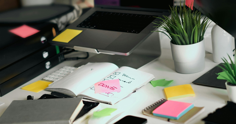 Organized Workspace with Checklists and Laptop
