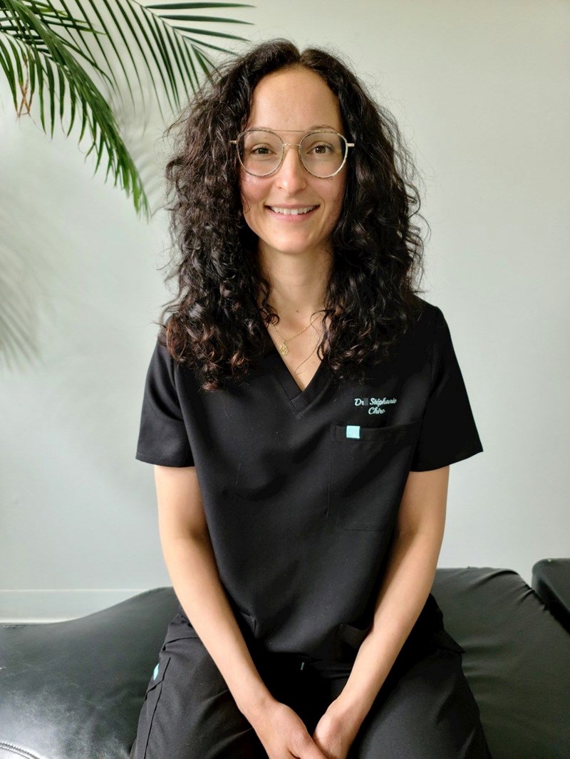 A woman wearing black scrubs, the uniform required of all employees at this spa, whether they work at the desk or in the back. 