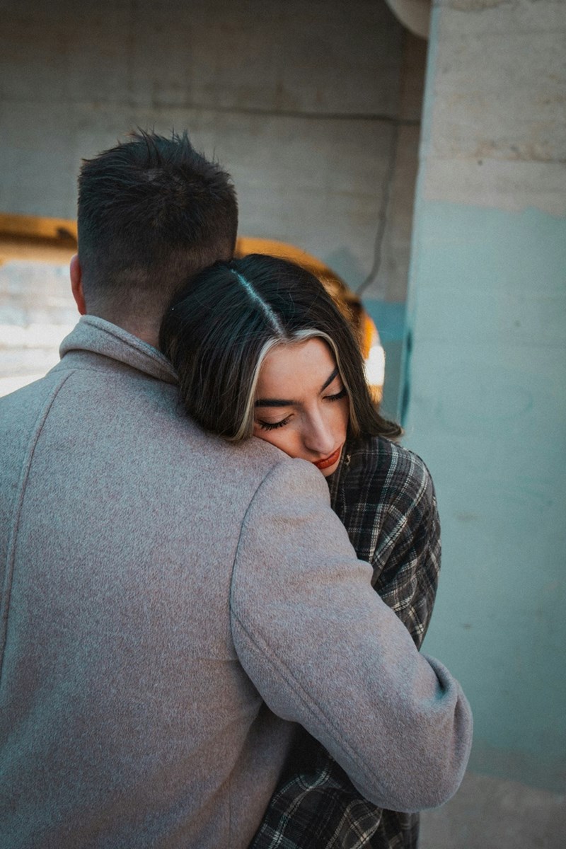 two people embracing outdoors with a relaxed mood