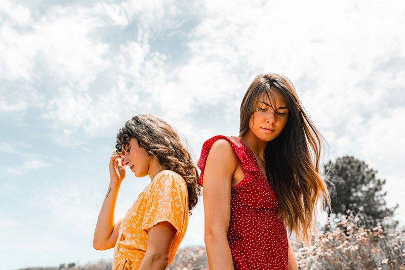 two woman looking away from each other