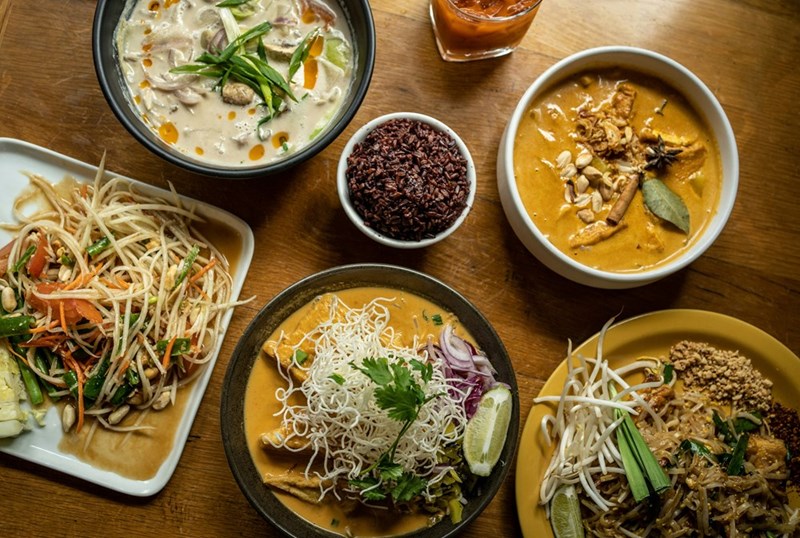An illustration of traditional Thai dishes served at a restaurant during a family birthday celebration.