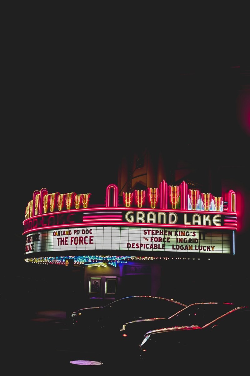 An illustrative image of cars parked at a drive-in movie theater during a popular movie premiere night.