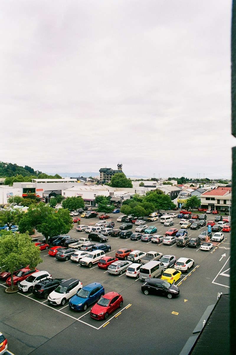 A representation of a busy parking lot filled with vehicles searching for available parking spaces.