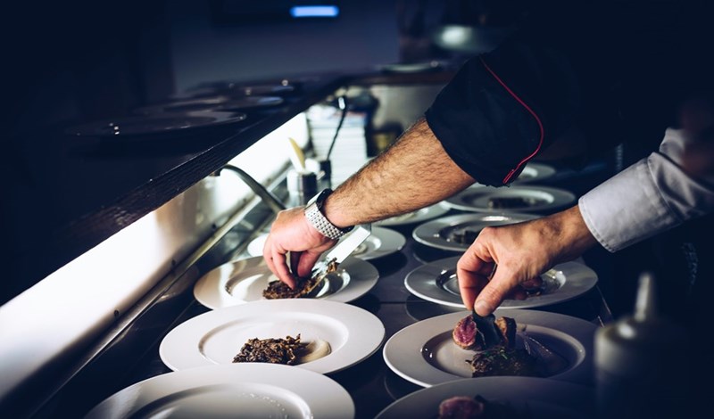Picture of what could be the restaurant workers preparing a dish.