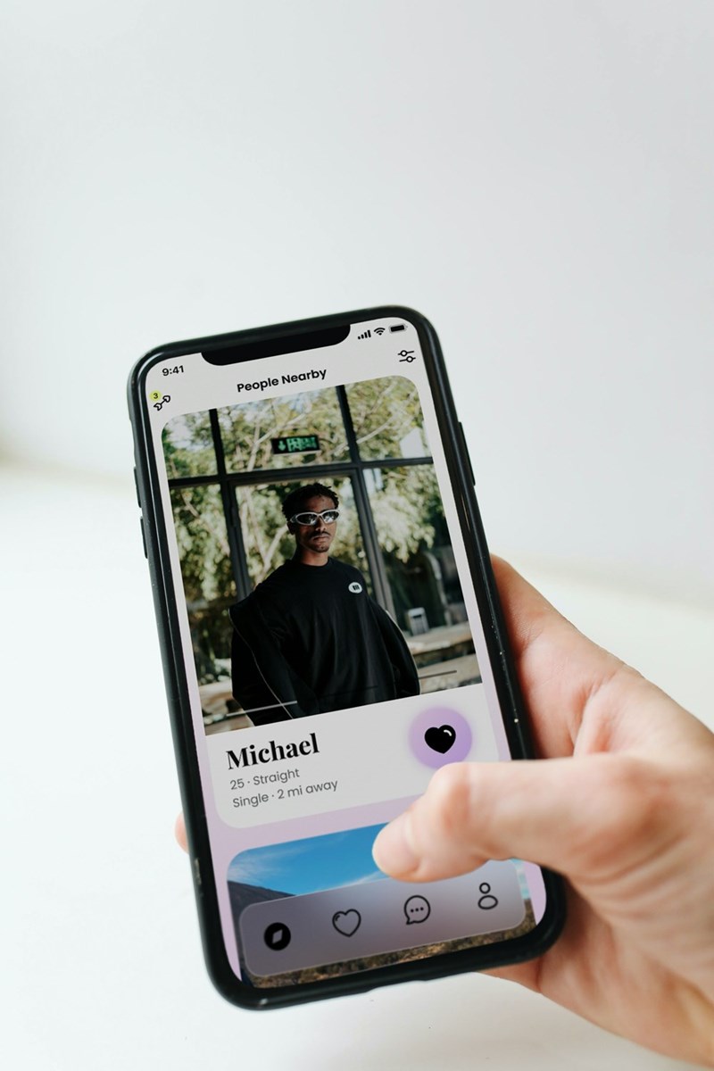 An illustration of a young woman browsing a dating app while looking for a meaningful connection online.