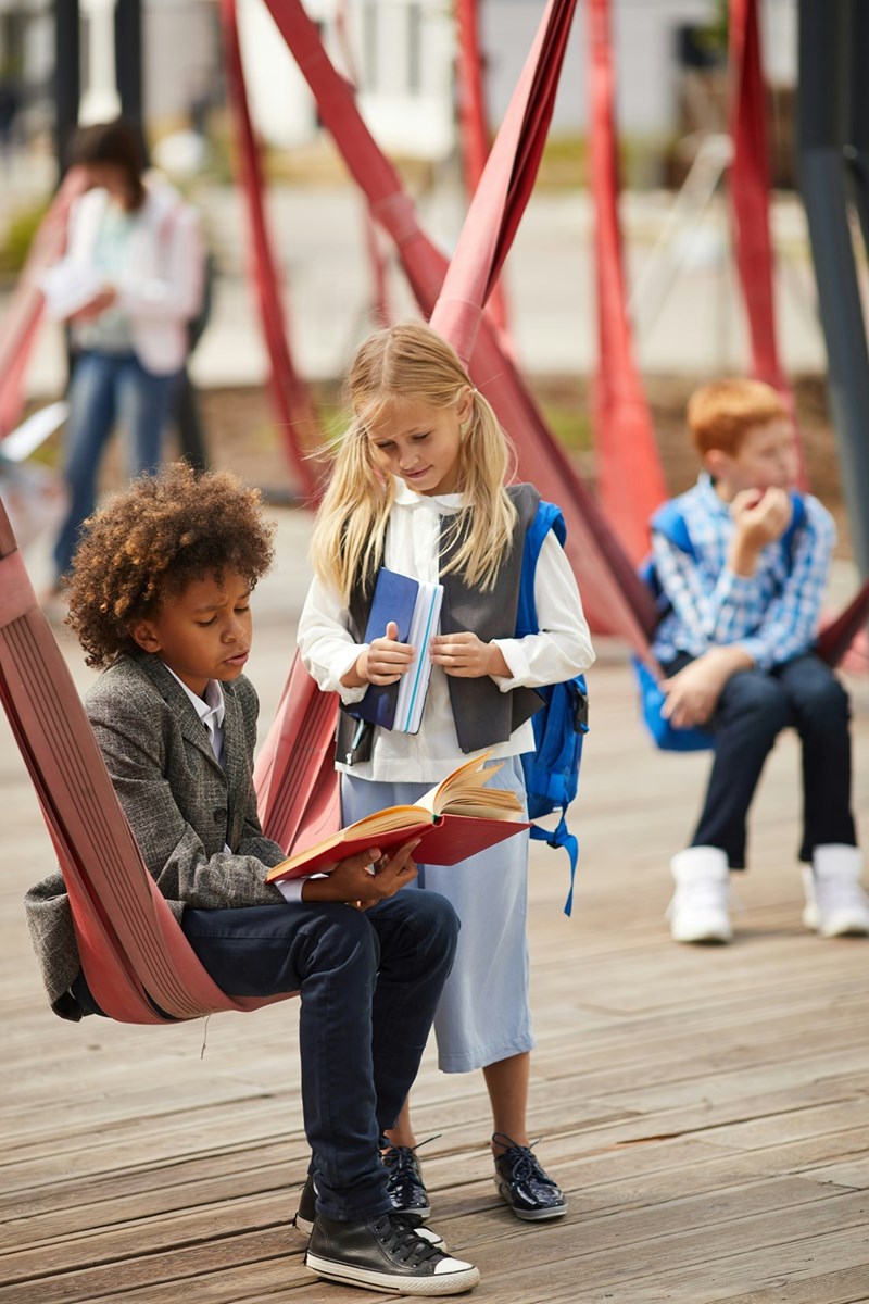 An illustration of a quiet elementary school playground representing a childhood crush and an old school memory.