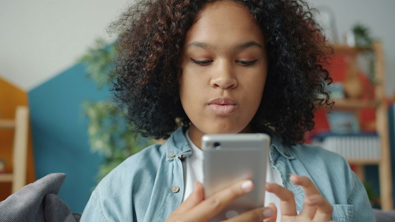 young woman looking at smartphone screen