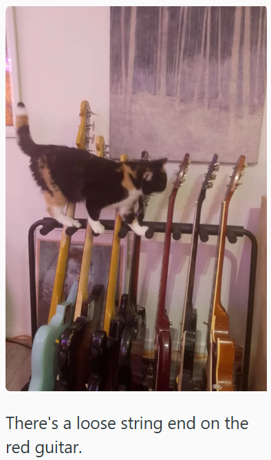 There's a loose string end on the red guitar.