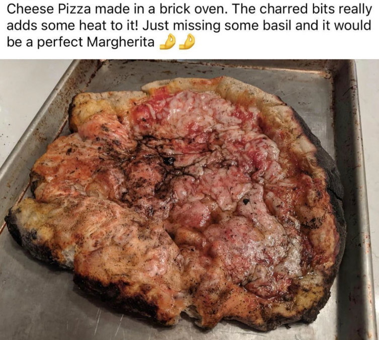 Cheese Pizza made in a brick oven. The charred bits really adds some heat to it! Just missing some basil and it would be a perfect Margherita