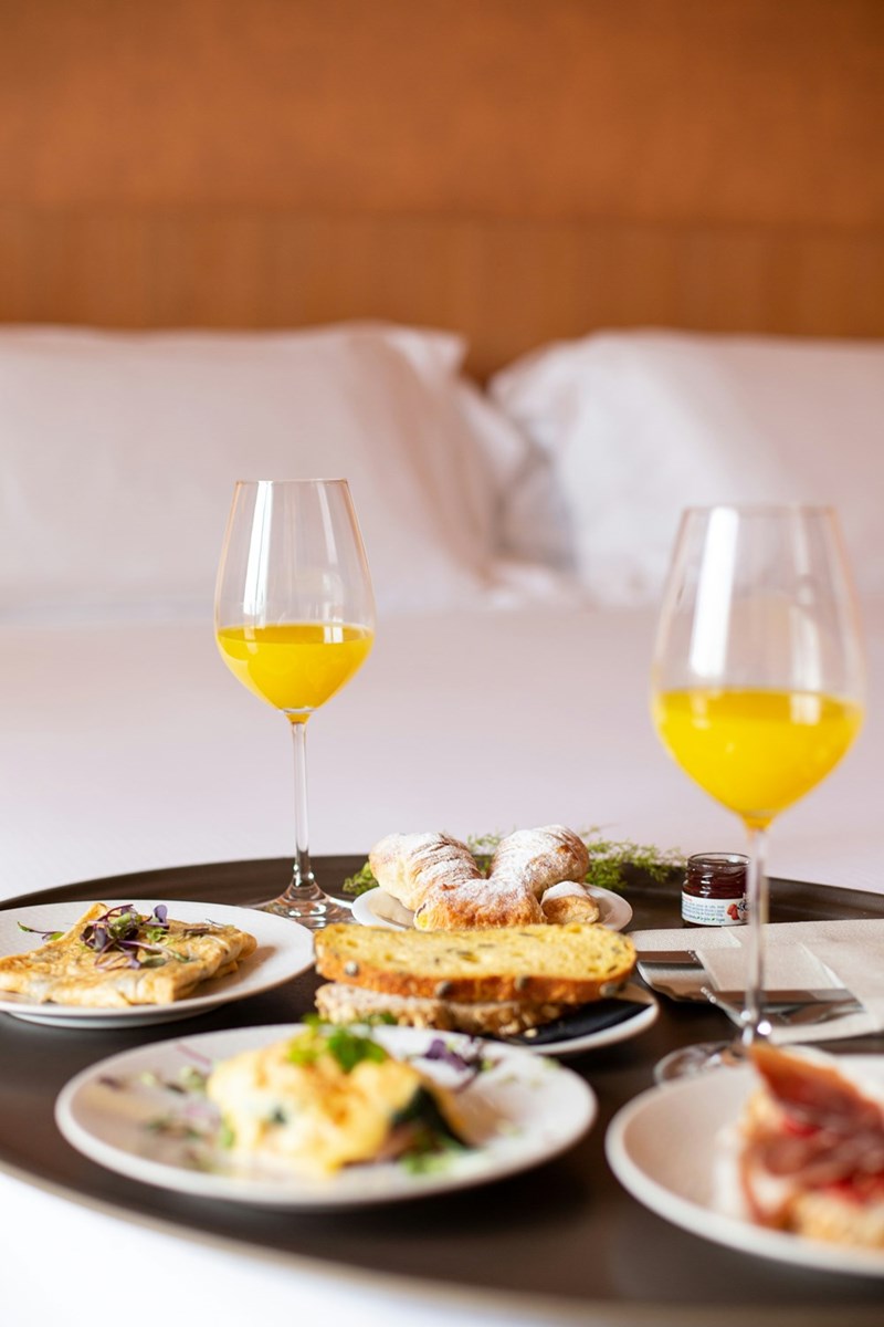 Breakfast with orange juice, toast, and other pastries.