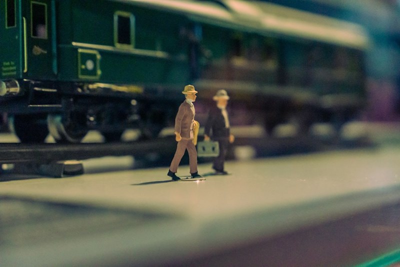 a couple of figurines coming out of a miniature train