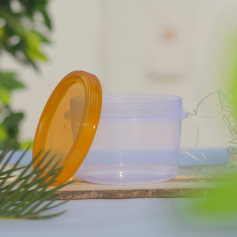 An illustrative reusable food container meant to be filled with leftovers after a friend brings her own Tupperware to a restaurant.