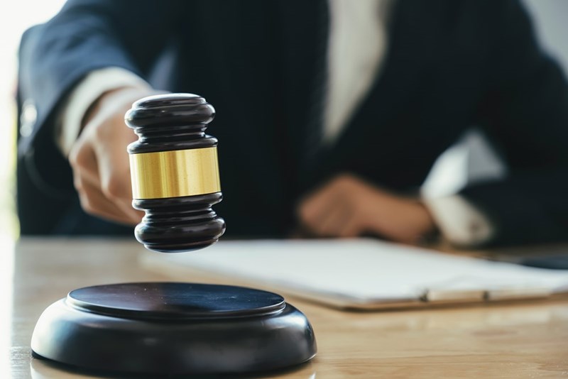 Male actor showcasing concept of a lawyer in an office with a gavel.