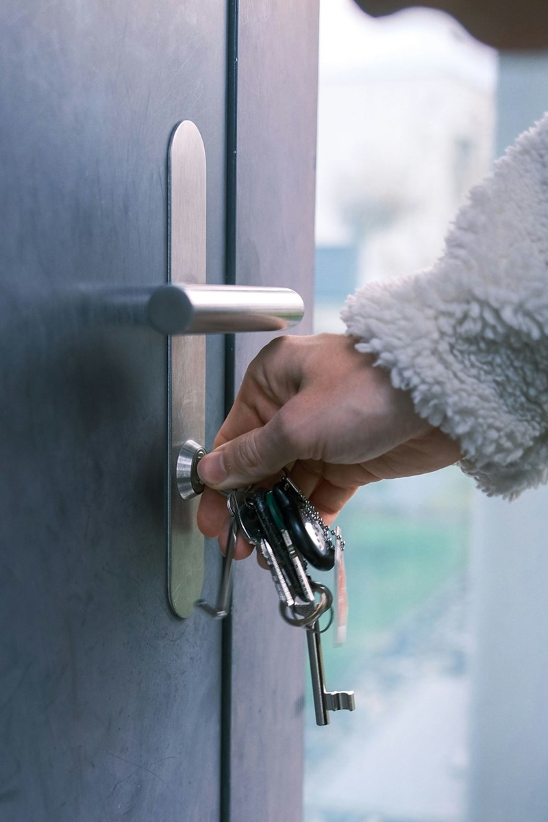 A representation of a sister opening a front door, illustrating family drama over access to someone else's home.