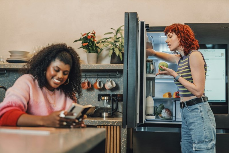 A woman opening her sister's refrigerator, helping herself to someone else's food, represented by a model.