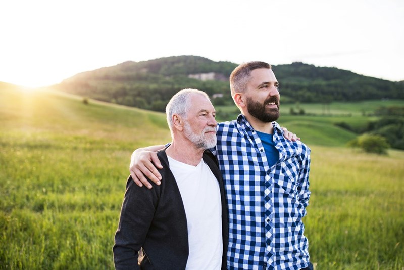 Two men share a smile together over a shared hobby