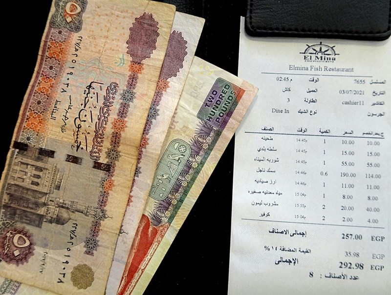A paper bill with money to pay for it.