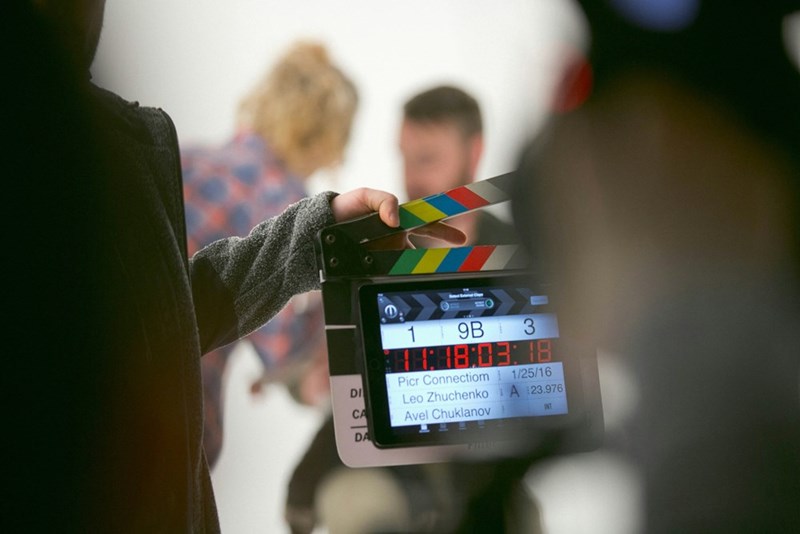 Film students use a clapboard between takes as they film their school project.