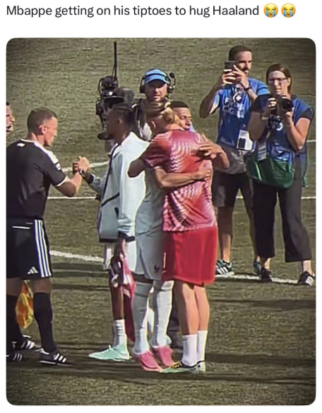 Mbappe getting on his tiptoes to hug Haaland