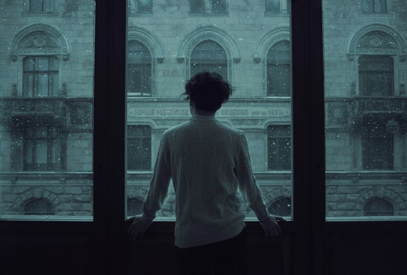 man standing in front of a window