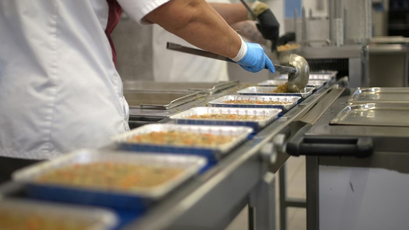 A person working in the fryer of a food chain.