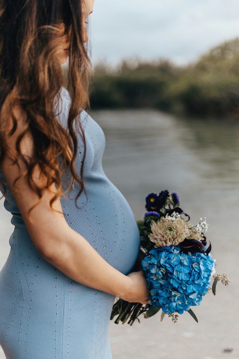 A mom-to-be at her family member's wedding ceremony. 