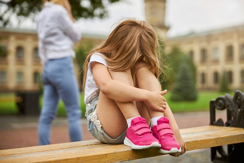 A little girl who is sad that her older brother is telling her to be quiet and that her opinion doesn't matter.