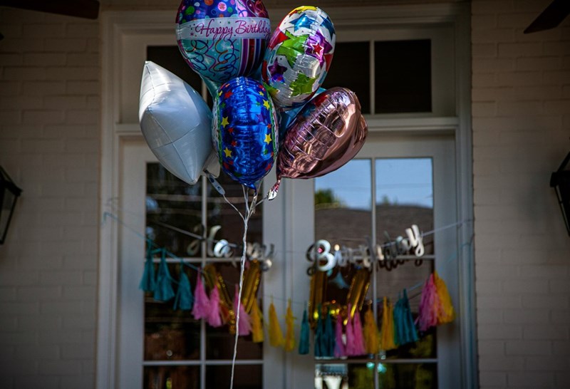 A representation of happy birthday balloons for a teenage birthday celebration affected by family favoritism.