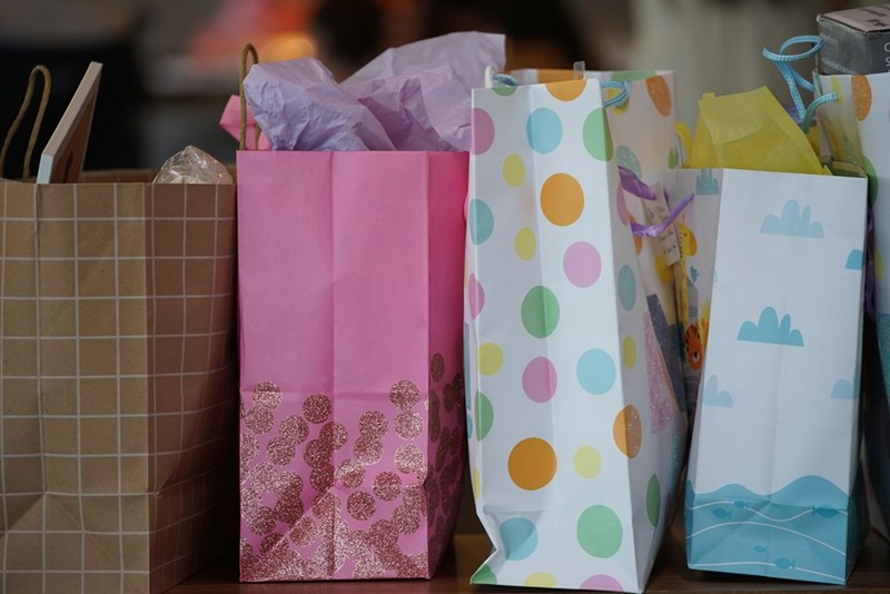 Shopping bags after a $2K shopping trip meant to make an overlooked niece feel celebrated, represented by a model.