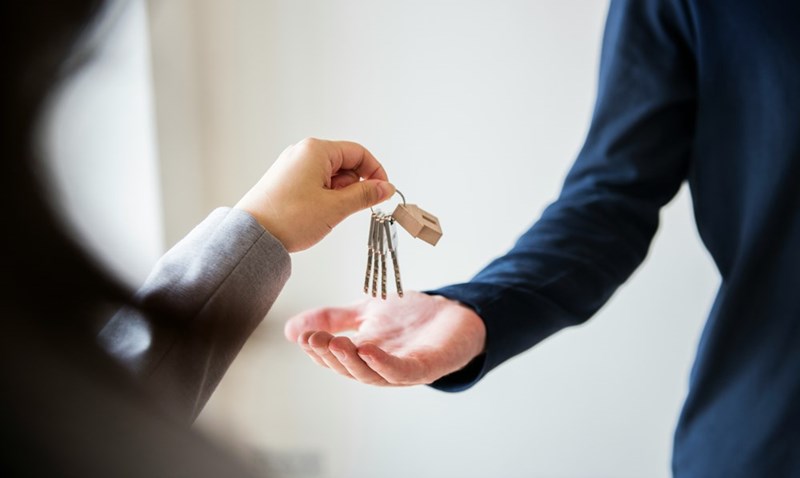 An ex-wife returning her ex-husband his house keys, illustrating a boundary conflict.