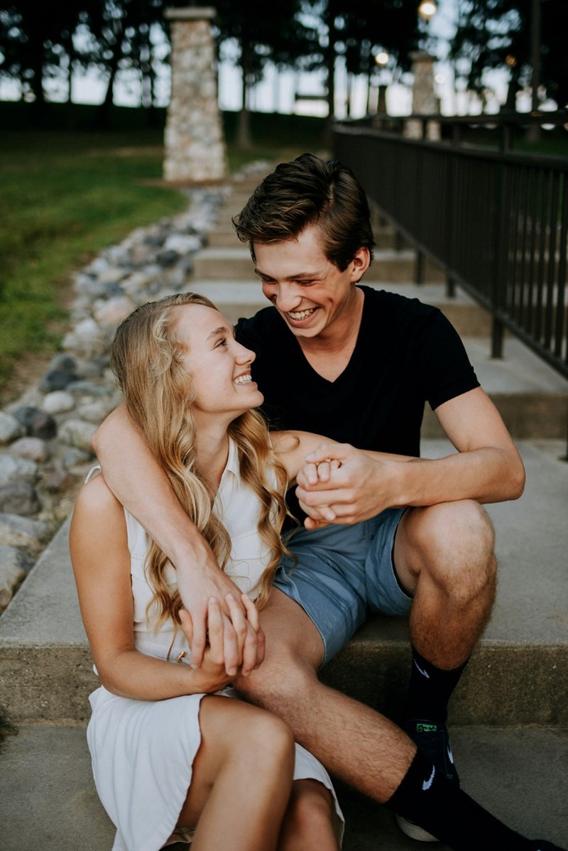 teenage couple smiling and holding hands