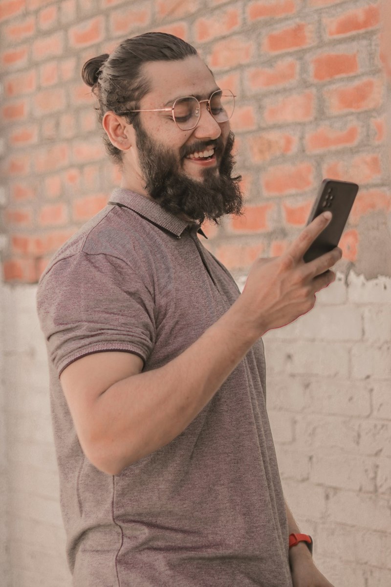 a man smiling at cellphone