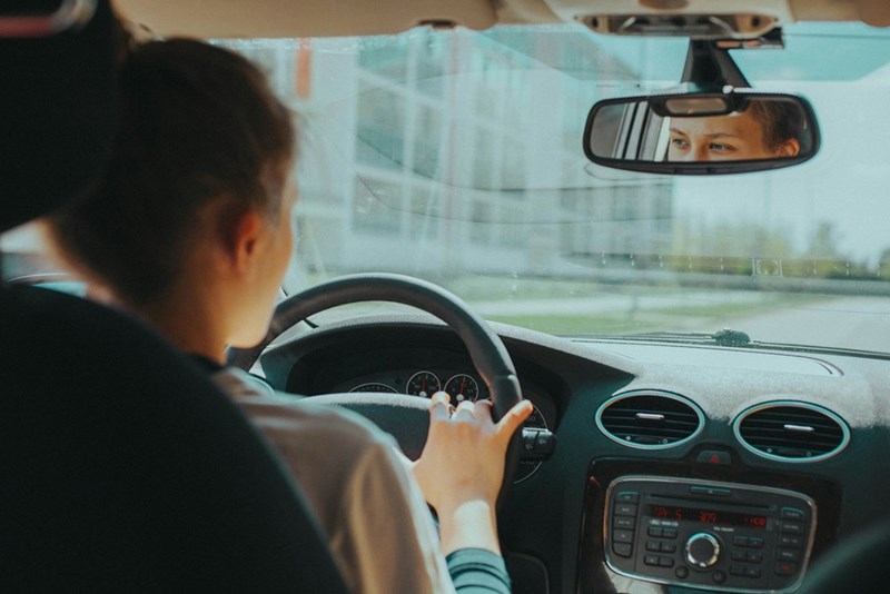 woman in black shirt driving
