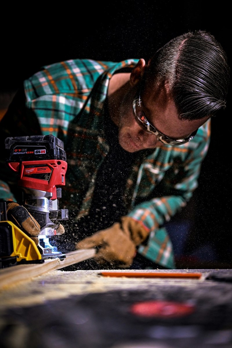 Man sawing wood in a shop.