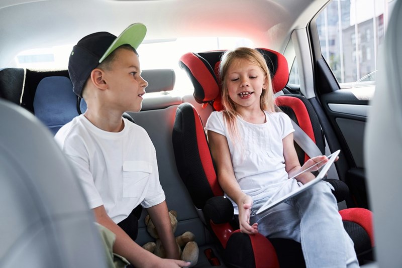 Kids playing on an iPad on a long road trip instead of during their day-to-day life.