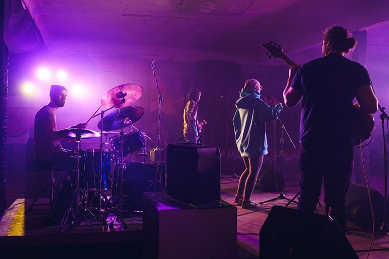 Band playing live, representing a couple's favorite artist's concert.