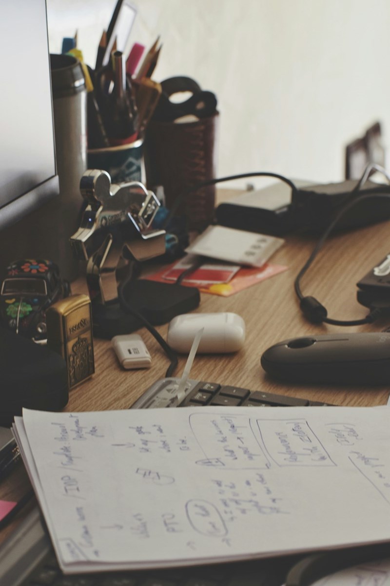 a desk with a notebook with some notes
